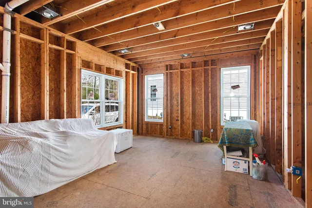 a view of a porch with a door and wooden floor