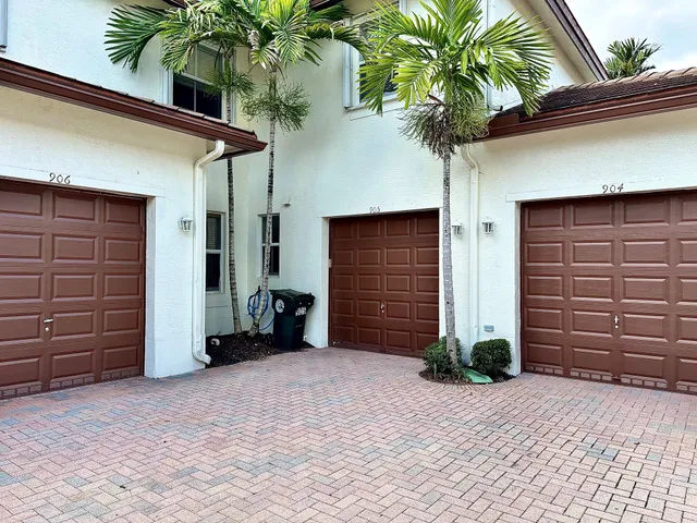 a view of a house with a potted plant and a garage