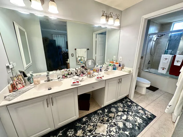 a bathroom with a sink double vanity and a mirror