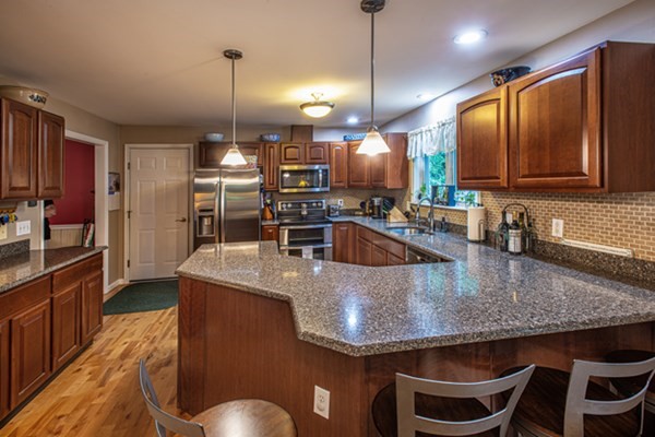 888 Florence Road Northampton, MA 01062 - Photo 11 of 37 a kitchen with kitchen island granite countertop a sink a counter top space appliances and cabinets