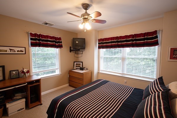 888 Florence Road Northampton, MA 01062 - Photo 29 of 37 a bedroom with a bed and a chandelier