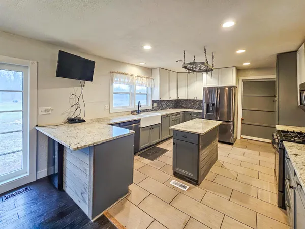 a kitchen with a stove a sink and a refrigerator