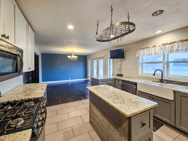 a view of a kitchen with granite countertop cabinets and a wooden floor