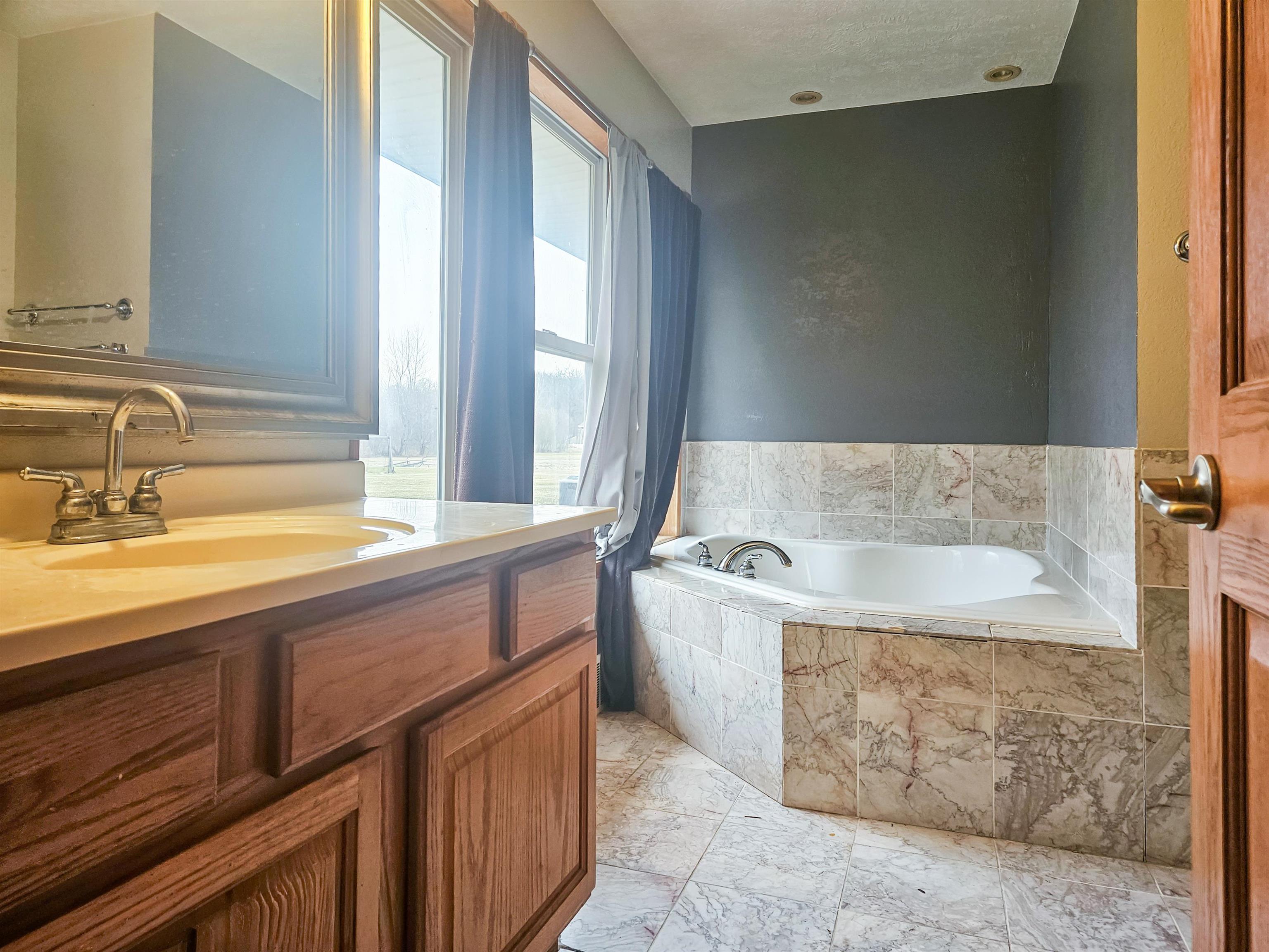 10582 Atwood Road Roscoe, IL 61073 - Photo 22 of 27 a spacious bathroom with bathtub and double vanity
