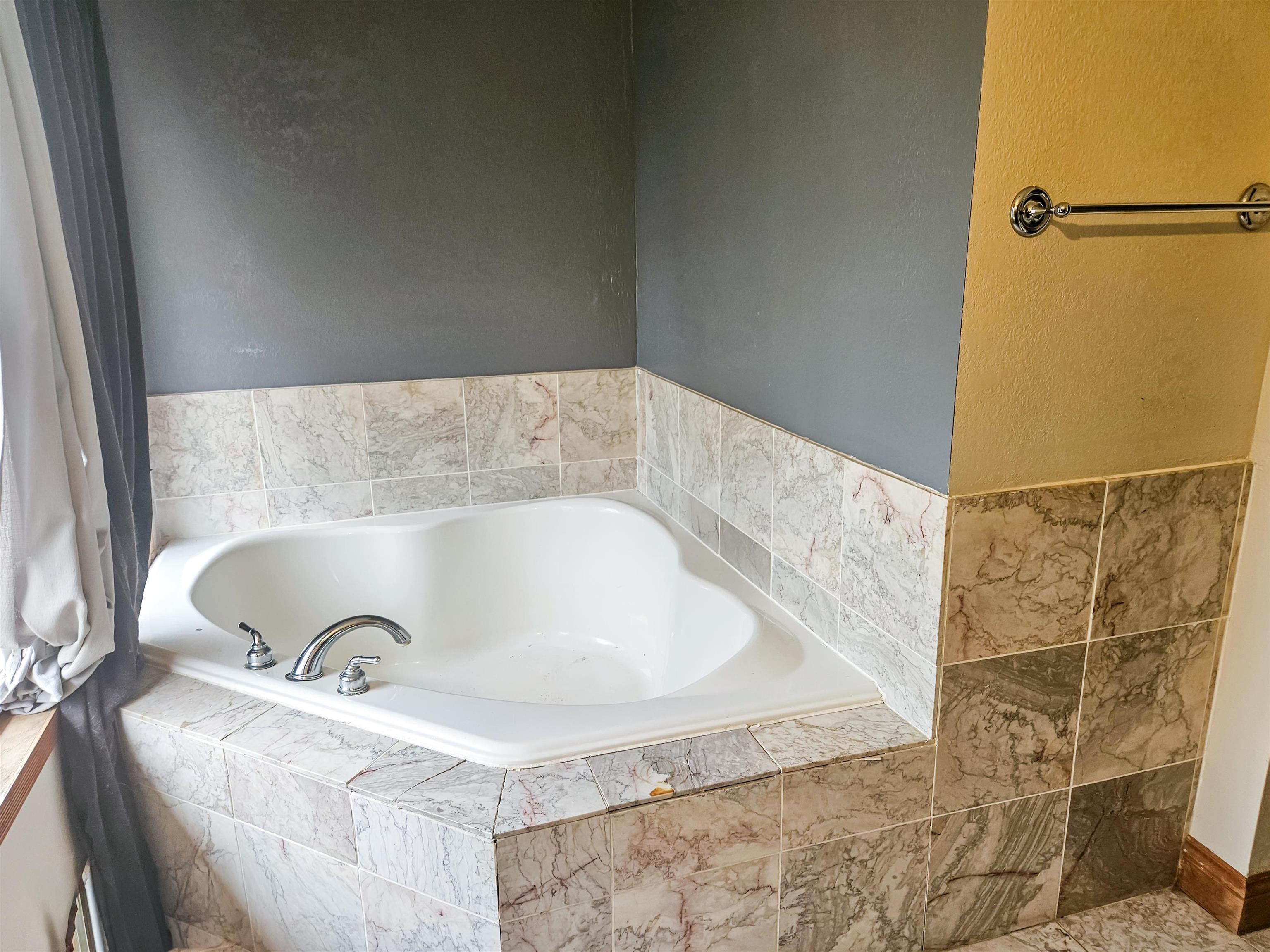 10582 Atwood Road Roscoe, IL 61073 - Photo 23 of 27 a bathroom with a tub and a shower