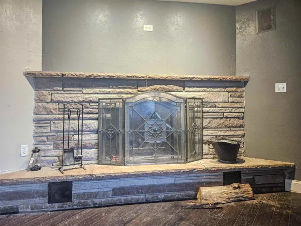 a view of an empty room with a fireplace