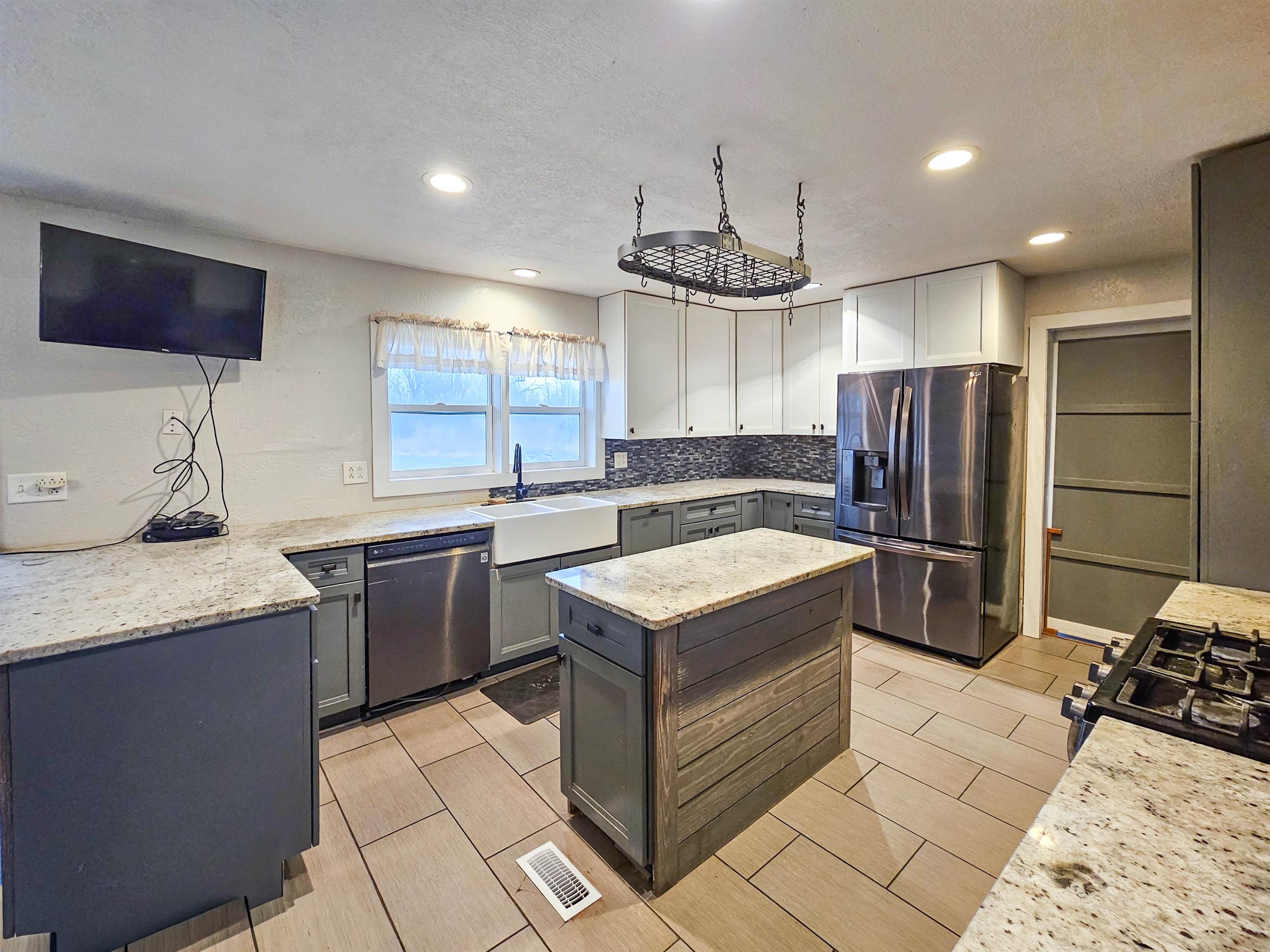 10582 Atwood Road Roscoe, IL 61073 - Photo 10 of 27 a kitchen with stainless steel appliances granite countertop a sink stove and refrigerator