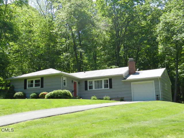 8 Bayberry Hill Road Ridgefield, CT 06877 - Photo 1 of 1 a front view of a house with a yard and trees