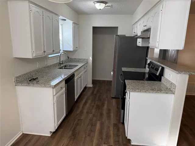 a kitchen with a sink and a refrigerator