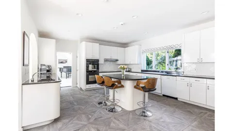 a kitchen with stainless steel appliances granite countertop a sink and cabinets