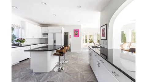 a kitchen with a sink appliances and cabinets
