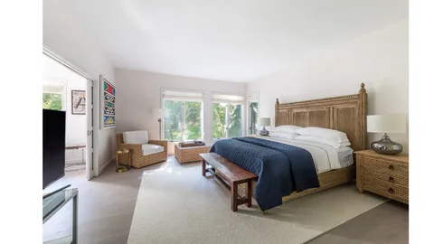 a bedroom with a bed and a couch