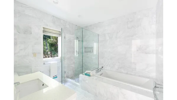 a bathroom with a bathtub and shower