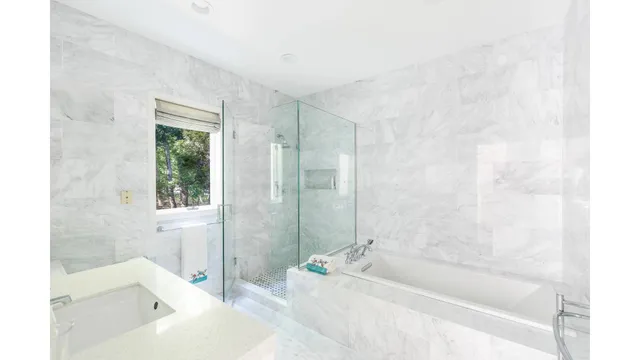 a bathroom with a bathtub and shower