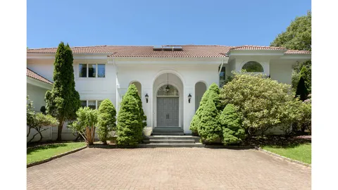 front view of a house with a garden
