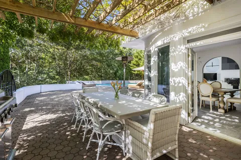a view of a patio with table and chairs and potted plants