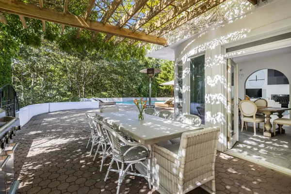 a view of a patio with table and chairs and potted plants
