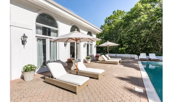 a view of a patio with swimming pool table and chairs