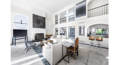 a living room with fireplace furniture and a fireplace