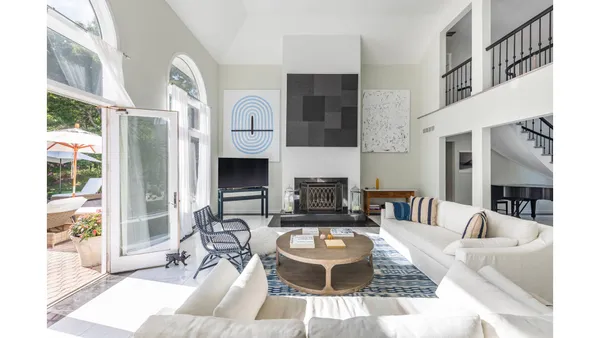 a living room with furniture a fireplace and a large window