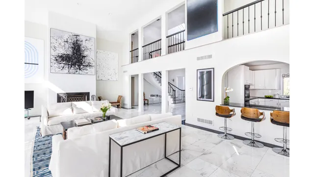 a living room with furniture and a mirror