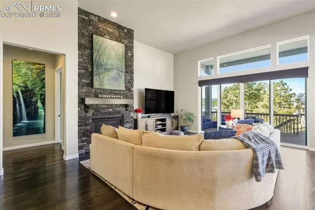 a living room with furniture large windows and a flat screen tv