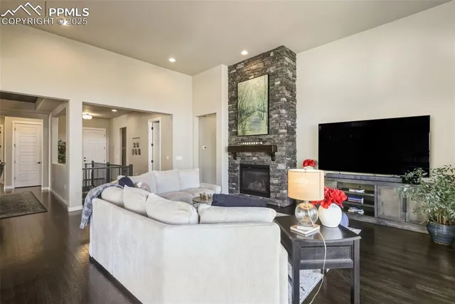 a living room with fireplace furniture and a flat screen tv