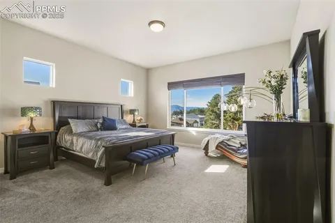 a bedroom with a bed and large window