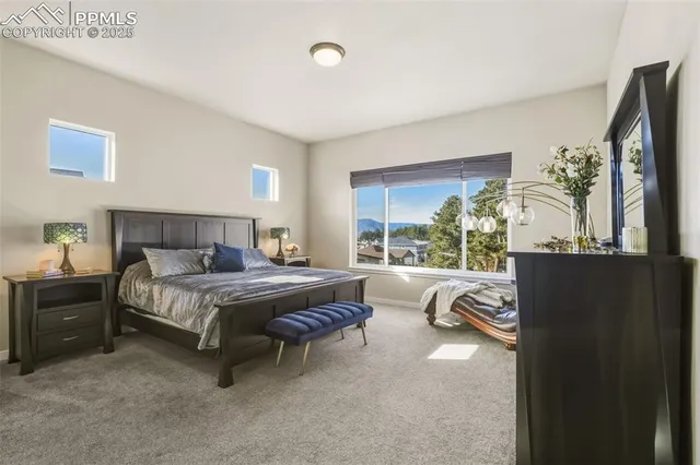 a bedroom with a bed and large window