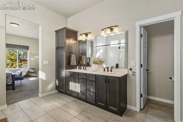 a bathroom with a double vanity sink and a mirror