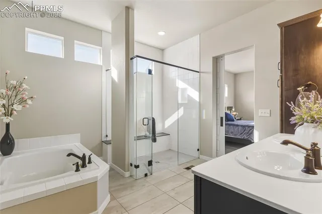 a bathroom with a sink a bathtub and a mirror