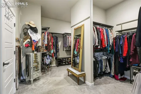 a view of walk in closet with clothes