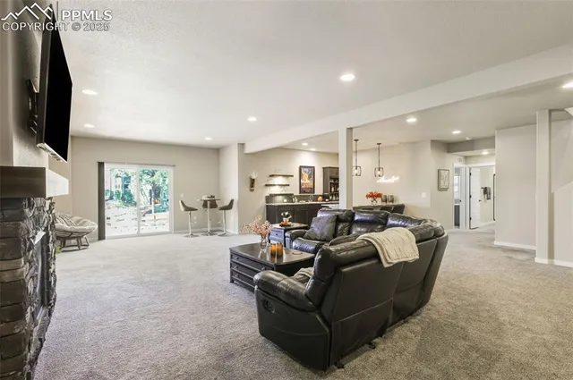 a living room with furniture a flat screen tv and a fireplace