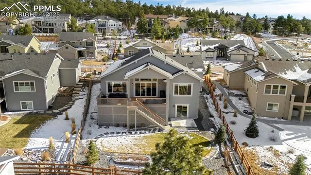 a view of a white house with a large pool and lawn chairs