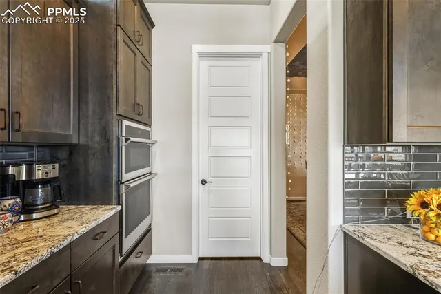 a kitchen with a stove and a refrigerator