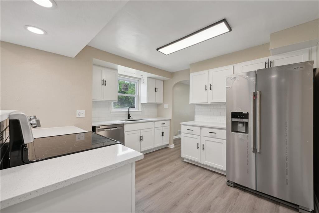 428 Beulah Road Pittsburgh, PA 15235 - Photo 11 of 39 a kitchen with white cabinets and stainless steel appliances