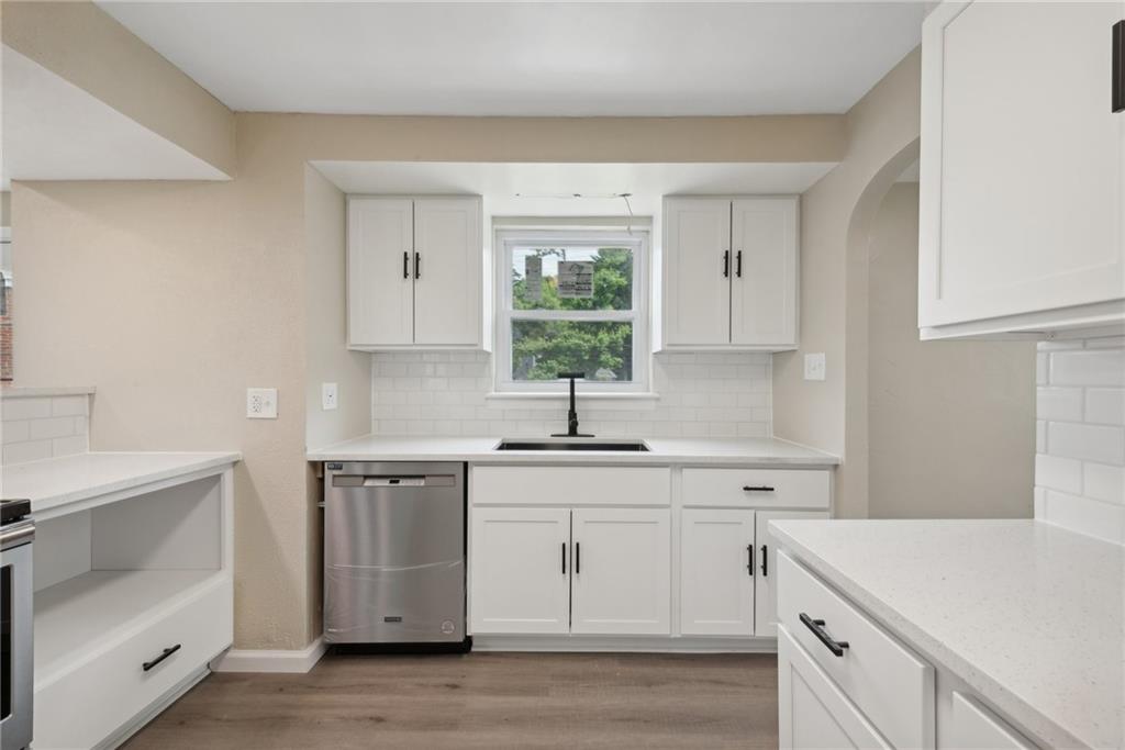 428 Beulah Road Pittsburgh, PA 15235 - Photo 13 of 39 a kitchen with white cabinets appliances and a window