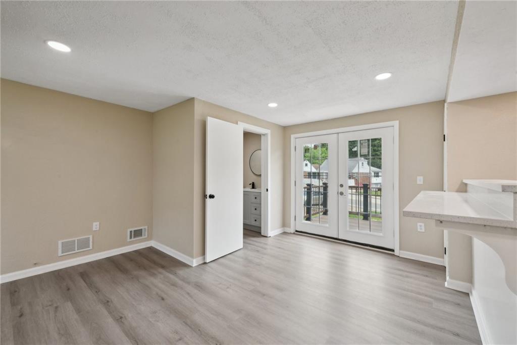 428 Beulah Road Pittsburgh, PA 15235 - Photo 17 of 39 a view of an empty room with wooden floor and a window