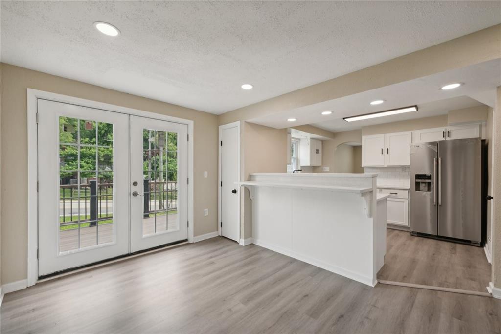 428 Beulah Road Pittsburgh, PA 15235 - Photo 18 of 39 a room with stainless steel appliances kitchen island wooden floor and large window