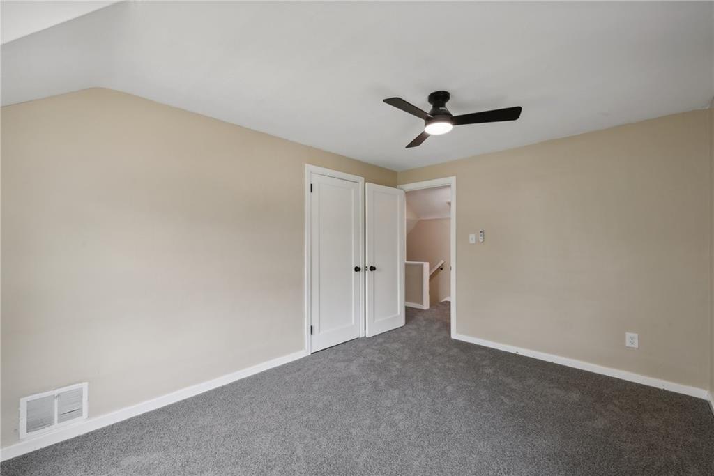 428 Beulah Road Pittsburgh, PA 15235 - Photo 28 of 39 an empty room with a ceiling fan and a window