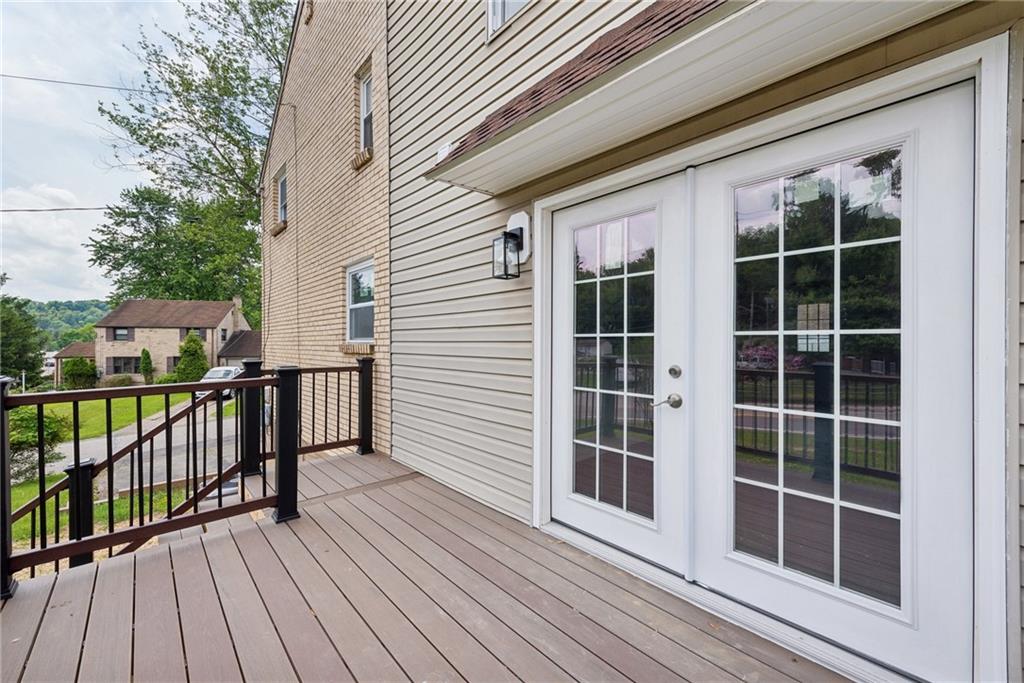 428 Beulah Road Pittsburgh, PA 15235 - Photo 35 of 39 a view of a balcony with wooden floor and fence and a floor to ceiling window