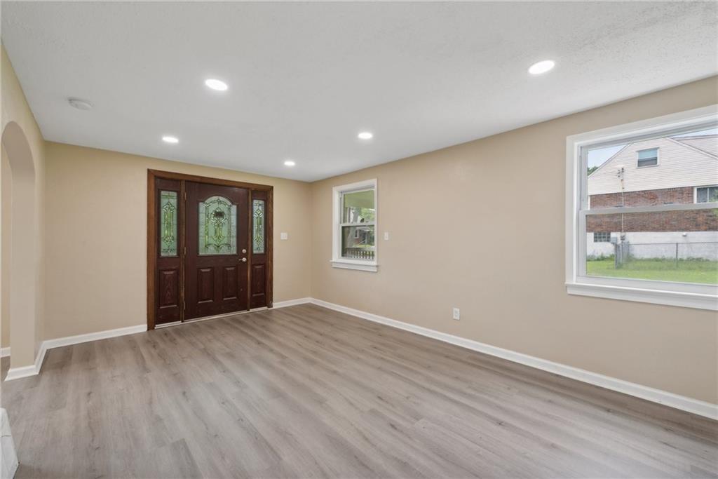 428 Beulah Road Pittsburgh, PA 15235 - Photo 5 of 39 a view of an empty room with wooden floor and a window