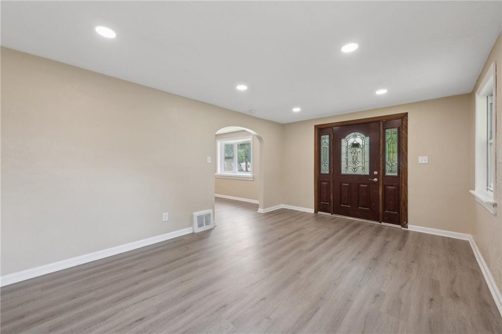 428 Beulah Road Pittsburgh, PA 15235 - Photo 6 of 39 a view of an empty room with wooden floor and a window