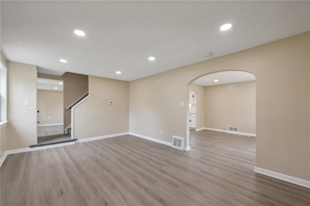 428 Beulah Road Pittsburgh, PA 15235 - Photo 8 of 39 a view of an empty room with wooden floor and a window