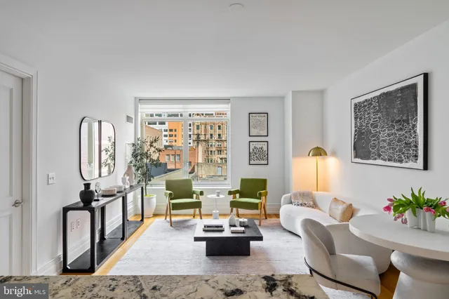 a living room with furniture fireplace and a window