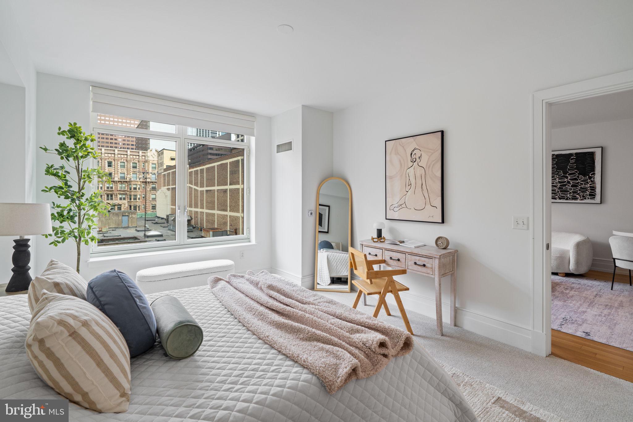 130 South 18th Street, Unit 501 Philadelphia, PA 19103 - Photo 22 of 43 a living room with furniture and a window