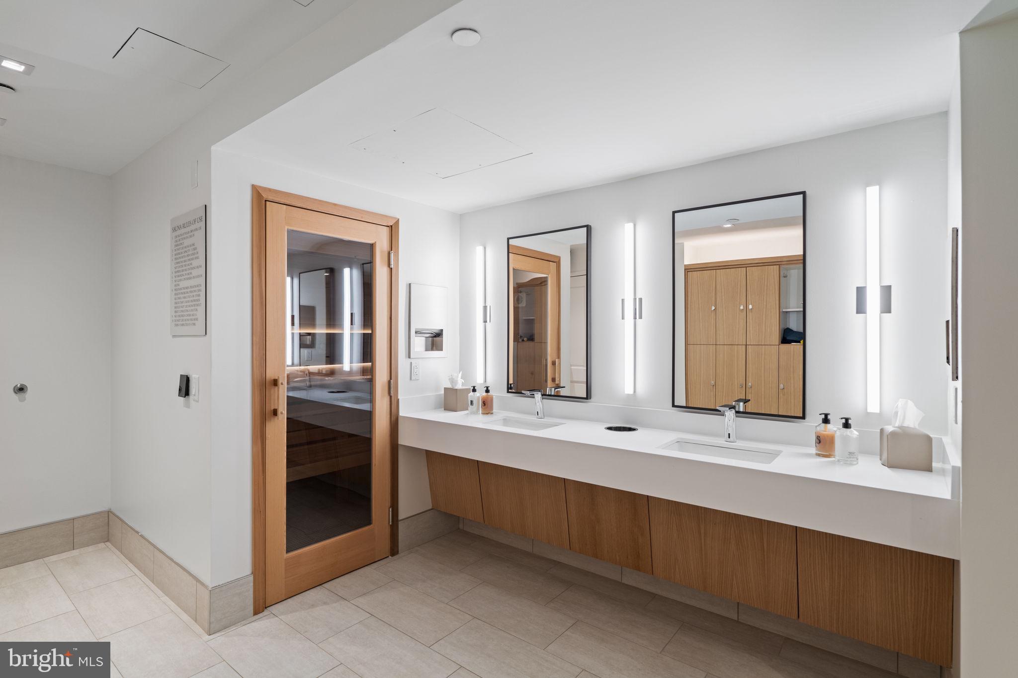130 South 18th Street, Unit 501 Philadelphia, PA 19103 - Photo 42 of 43 a bathroom with a double vanity sink and mirror