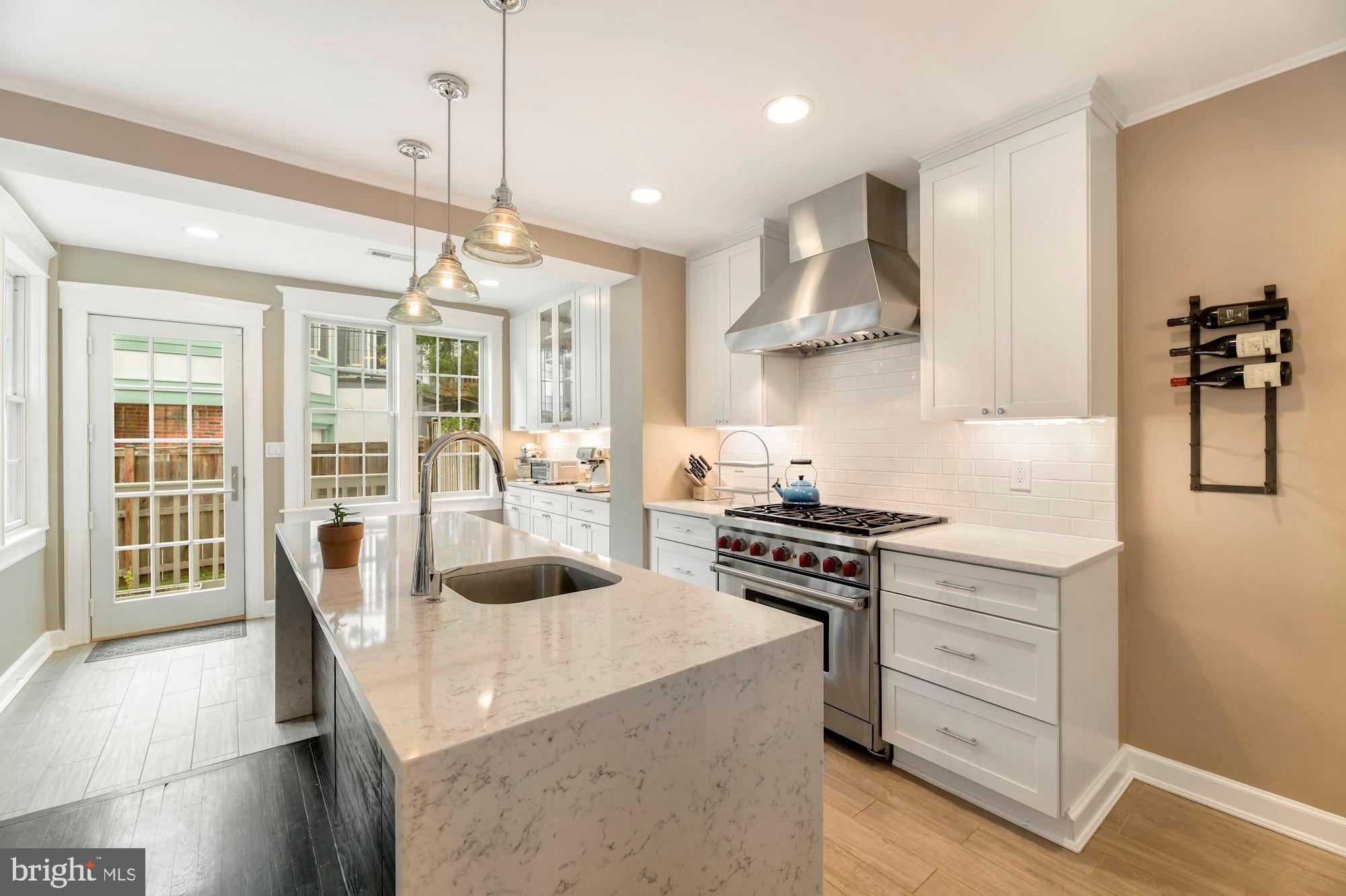1540 44th Street Northwest Washington, DC 20007 - Photo 13 of 39 Kitchen opens to sunroom/back yard.