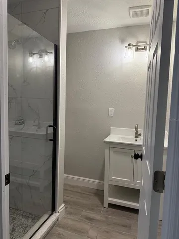 a bathroom with a shower and a sink