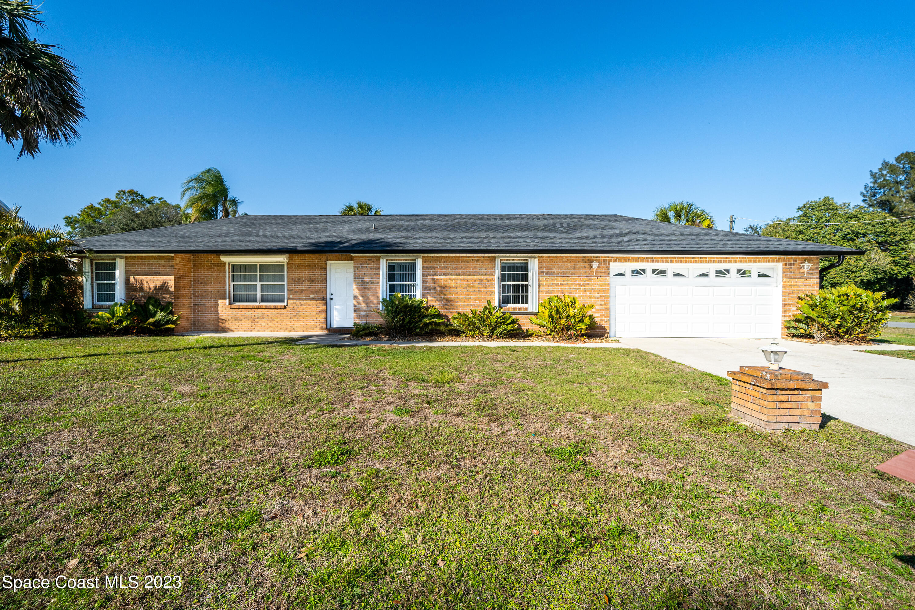 7746 Mango Grove Avenue Melbourne, FL 32904 - Photo 1 of 21 a front view of a house with garden